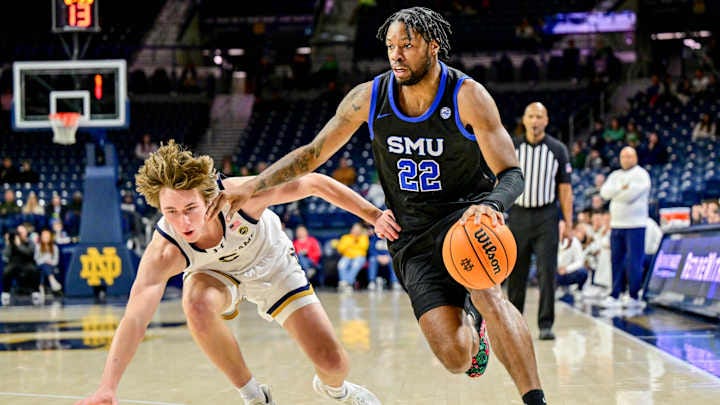 Feb 19, 2025; South Bend, Indiana, USA; SMU Mustangs forward Keon Ambrose-Hylton (22) dribbles as Notre Dame Fighting Irish guard Cole Certa (5) defends in the second half at the Purcell Pavilion. 