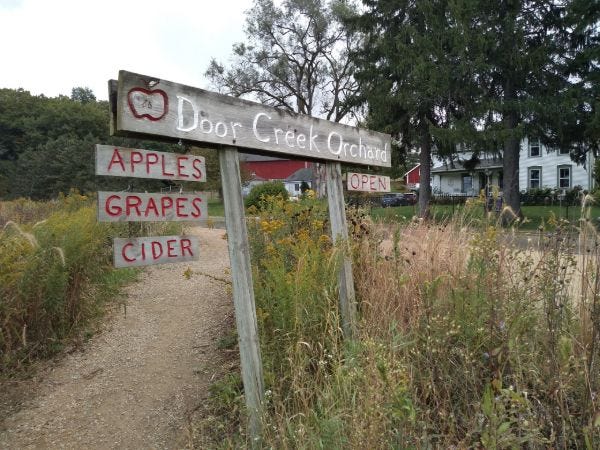 A sign for Door Creek Orchard