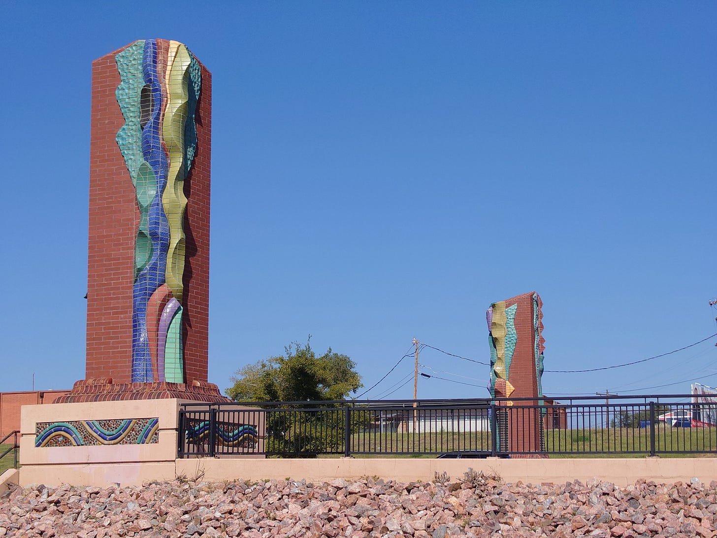 Southwestern-looking pillars at the end of a bridge over the Arkansas river in Pueblo