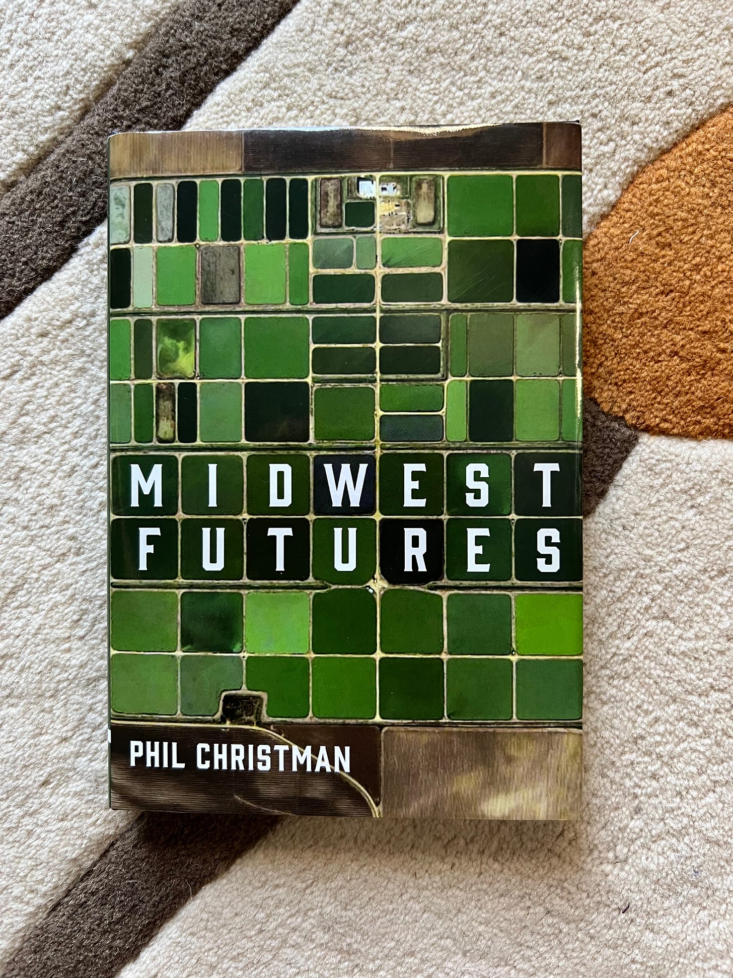 picture of the book Midwest Futures against a background of white, brown, and orange
