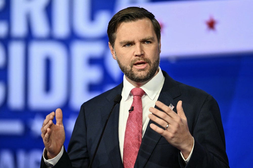 J.D. Vance holds his hands up while speaking.