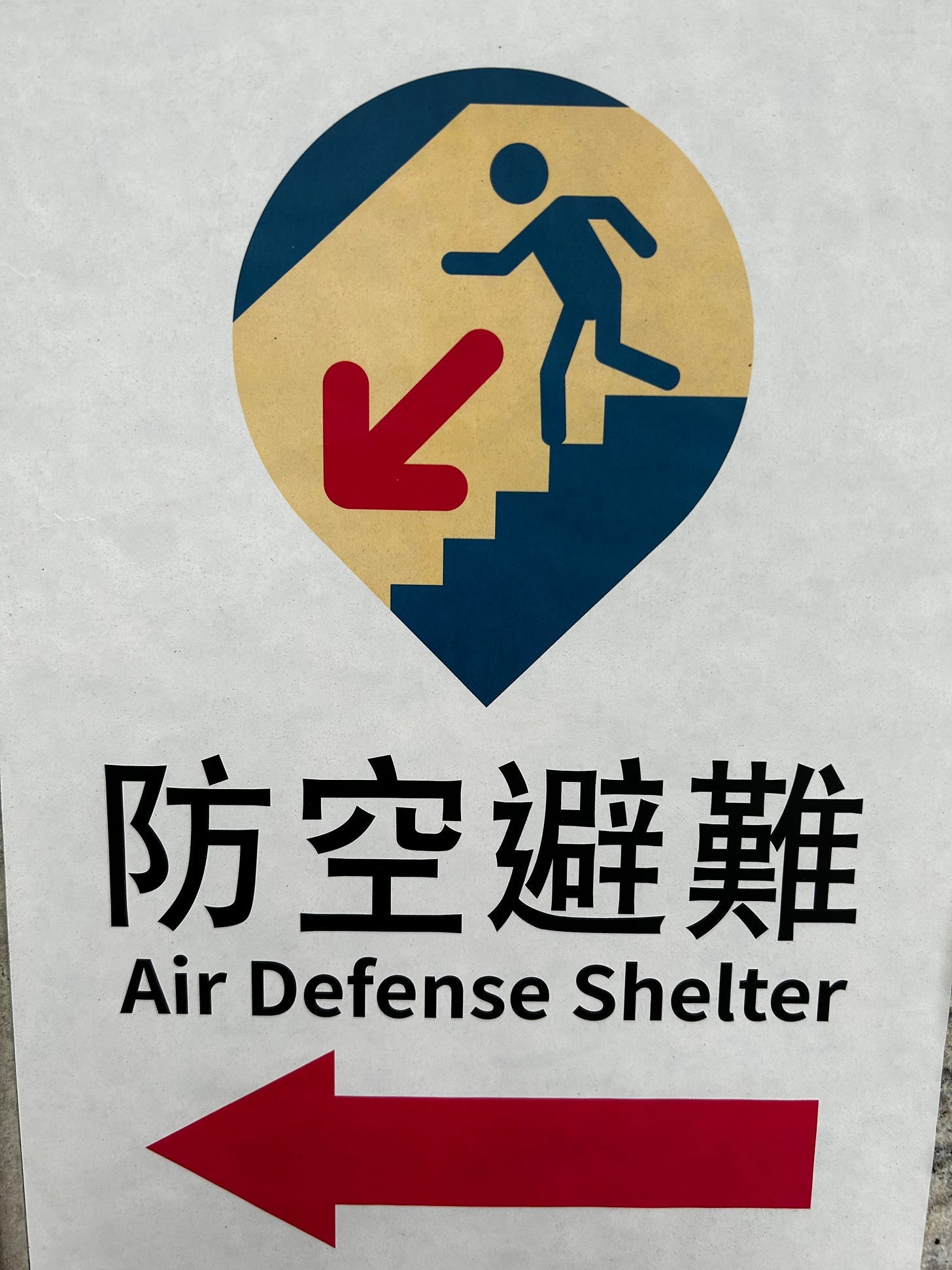 A sign with a person running up stairs and an arrow

Description automatically generated