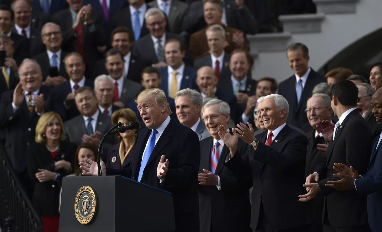 A photo of Donald Trump celebrating new corporate tax cuts in 2017.