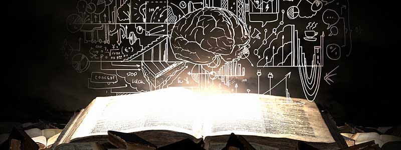 A white outline sketch of a brain and verios lines and items around a black background, hover over a pile of glowing books