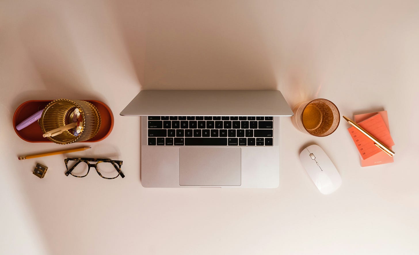 desktop with laptop and writing materials