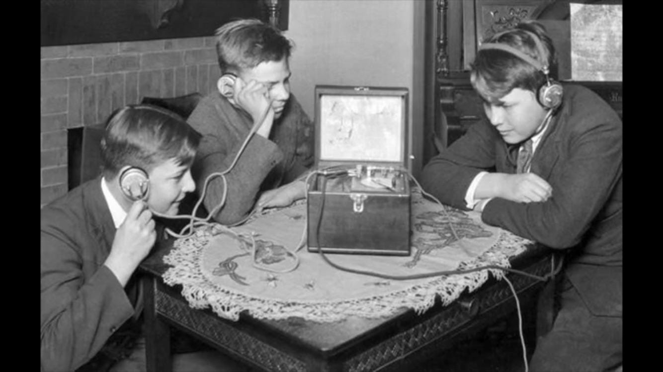 Kids listening to radio using headphones, 1920s. : r/OldSchoolCool