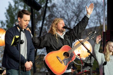 Christian musician Sean Feucht, right, prays with Sen. Josh Hawley, R-Mo., left, during a rally at the National Mall in Washington, Sunday, Oct. 25, 2020. (AP Photo/Jose Luis Magana)