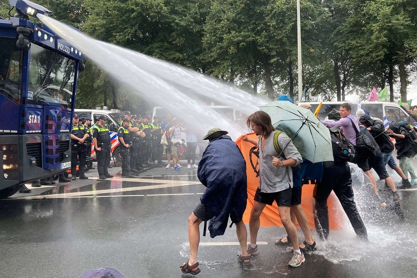 <p>Dutch police uses water cannon to clear climate activists from the highway in The Hague, Netherlands</p>