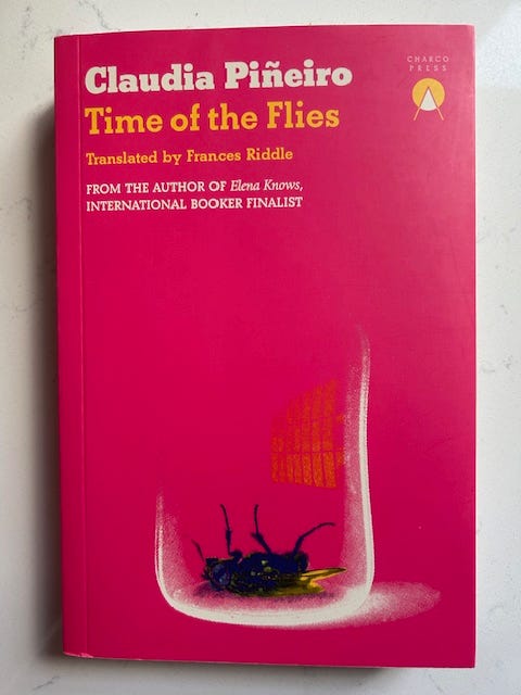 Time of the Flies by Claudia Pineiro has a pink cover with a dead fly in a jar