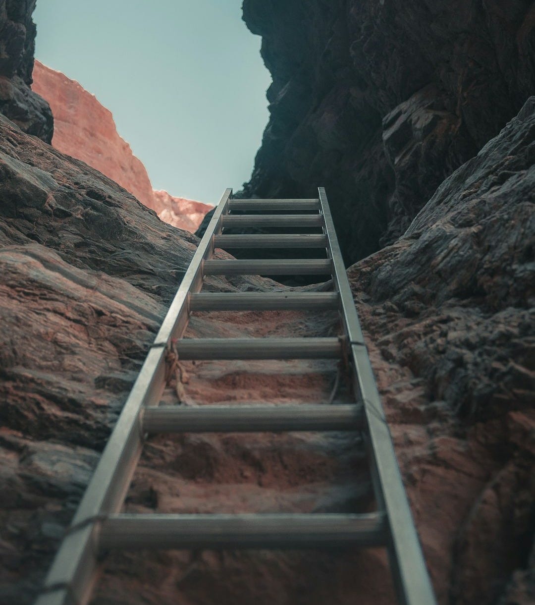 brown wooden staircase on brown rocky mountain during daytime
