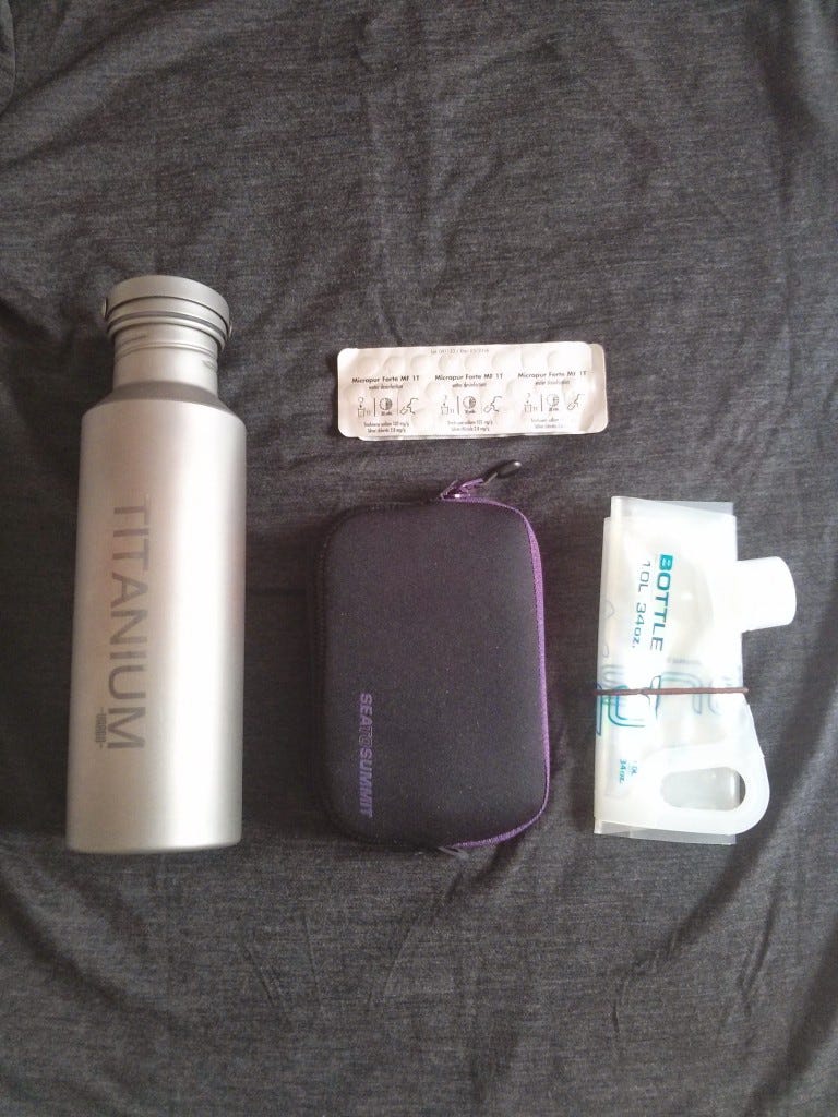 Clockwise: Vargo titanium water bottle, Katadyn Micropur Forte tablets, Platypus Plus 1L bottle, and Sea to Summit padded pouch (M)