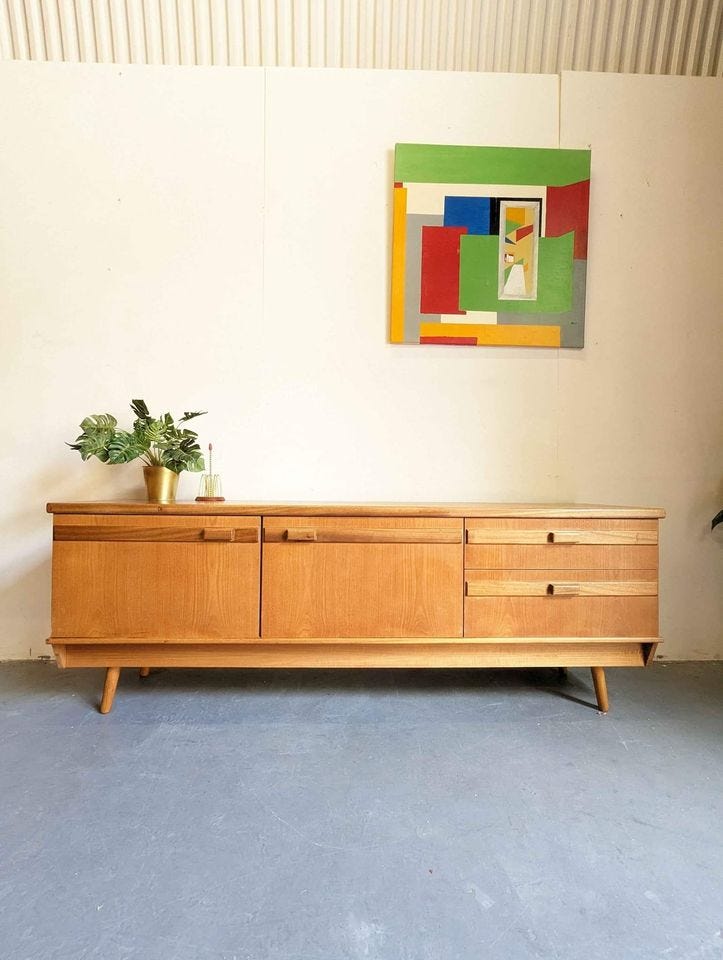 A gorgeous long sideboard with visible wood grain and svelte blocky handles.