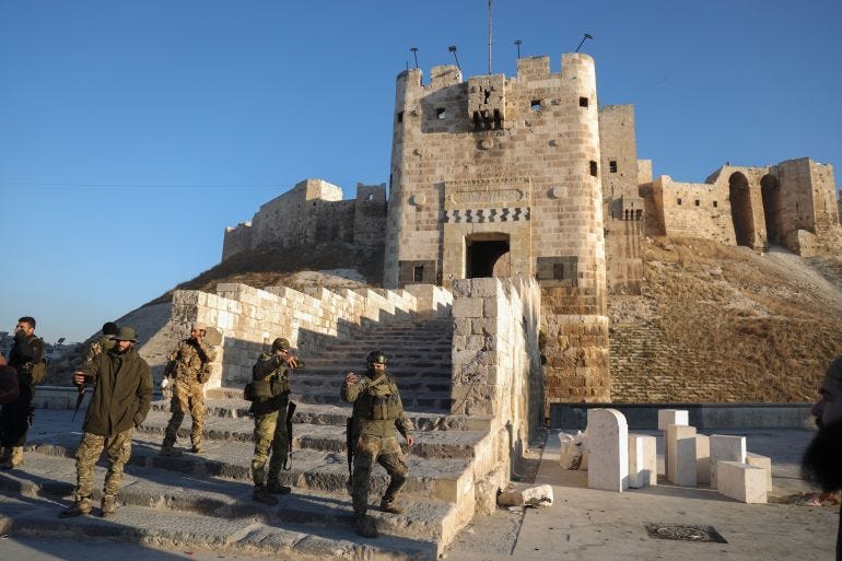 Fighters gather near the old city in Aleppo