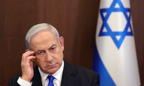 Israeli prime minister Benjamin Netanyahu next to the country's national flag.