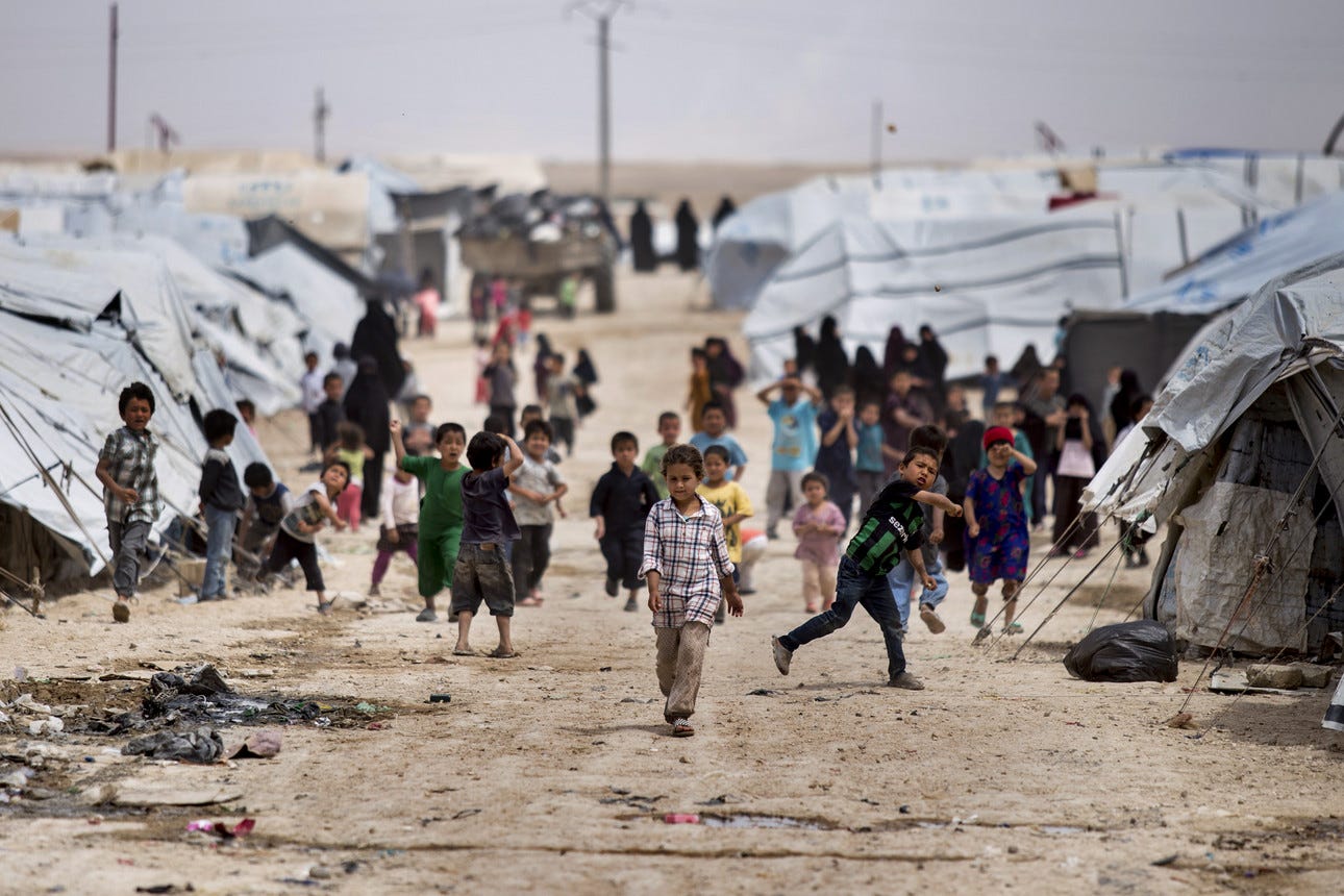 Children gather outside their tents at al-Hol camp.