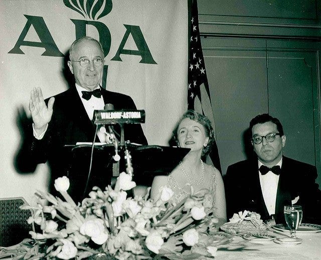 ADA History: President Truman speaking in front of an ADA banner.