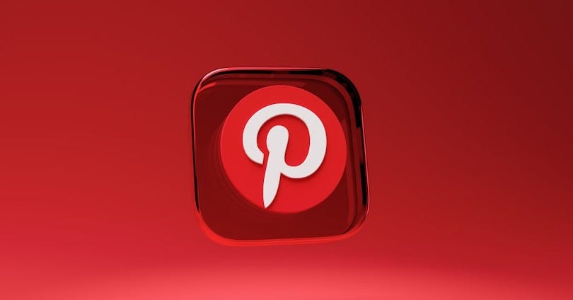 a red square button with a pin on it a red square button with a pin on it
