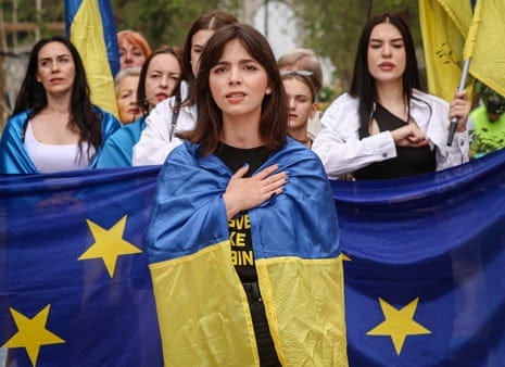 Supporters of Ukraine and Georgia carry a EU flag as they stage a protest on the sidelines of a European Council in Brussels.