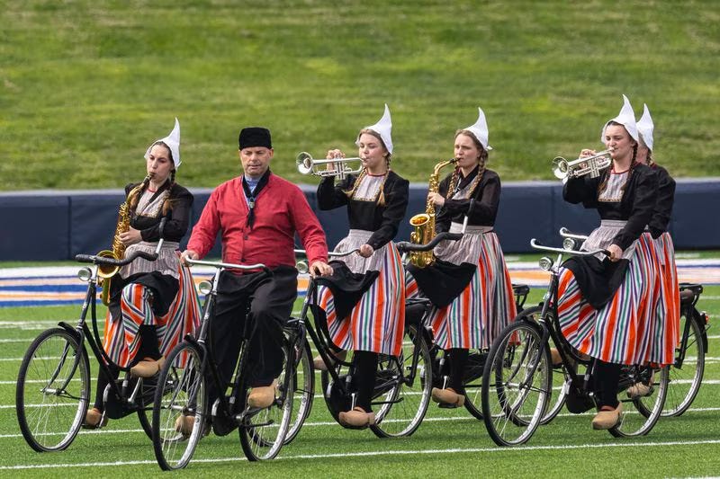 Dutch women on bikes with wind instruments in traditional costume (i..e a bit of a joke)