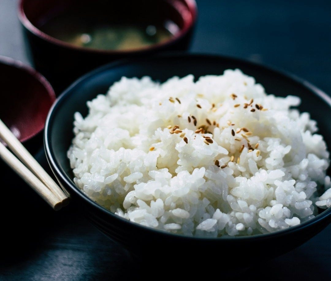 rice with sesame in black bowl