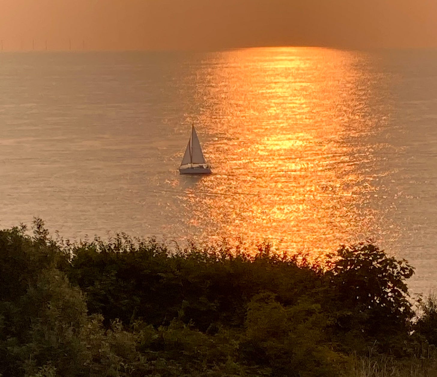 Sailing boat on sunset sea