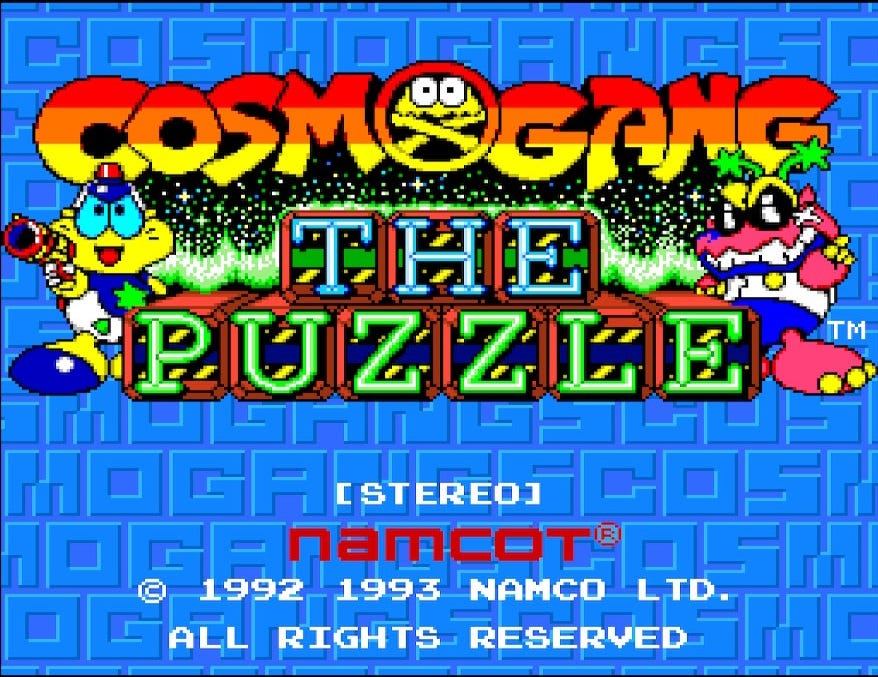 A screenshot of the title screen for Cosmo Gang The Puzzle, featuring the Cosmo Gang and the little alien creatures you'll be defeating around the logo. The background is entirely blue lettering on a blue background that says "Cosmo Gang" in block betters.