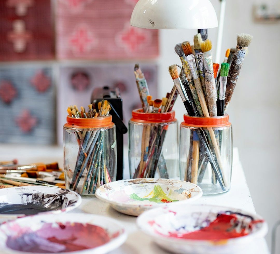 white ceramic plate with paint brushes and paint brushes white ceramic plate with paint brushes and paint brushes
