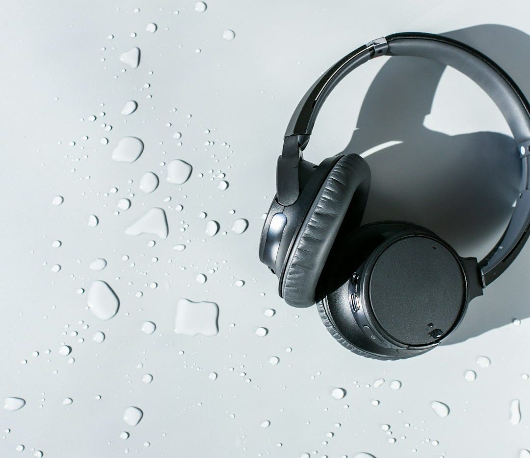 black and silver headphones on white surface