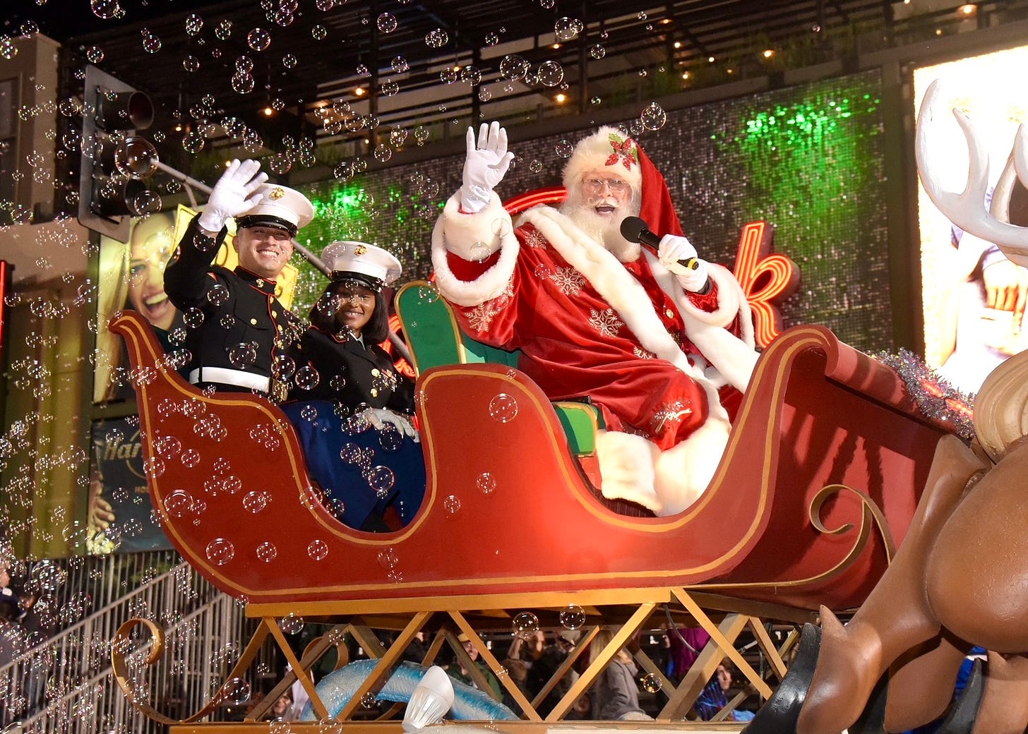 Santa ways to the crwod from atop a parade float