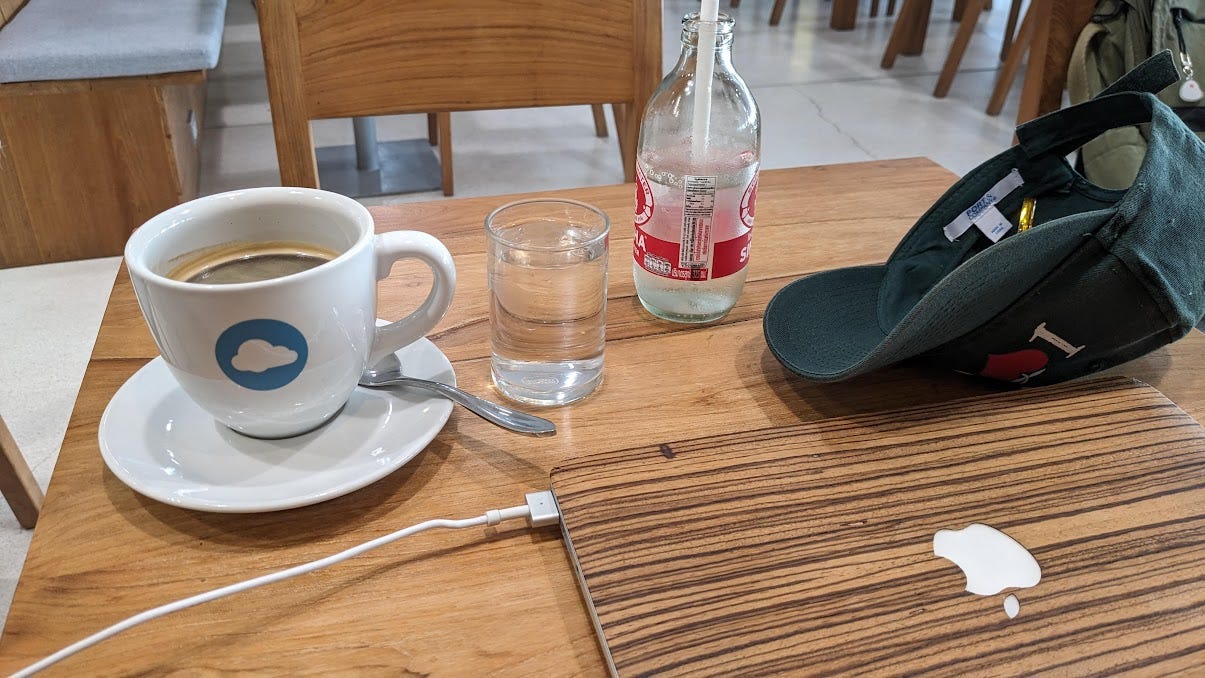 hot americano in a mug and laptop