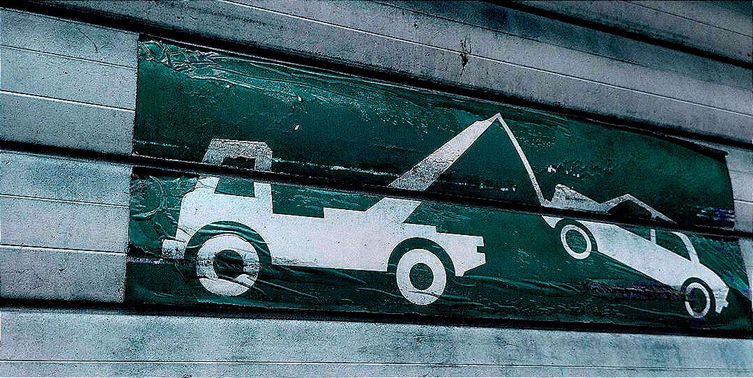 a green and white sign on the side of a building