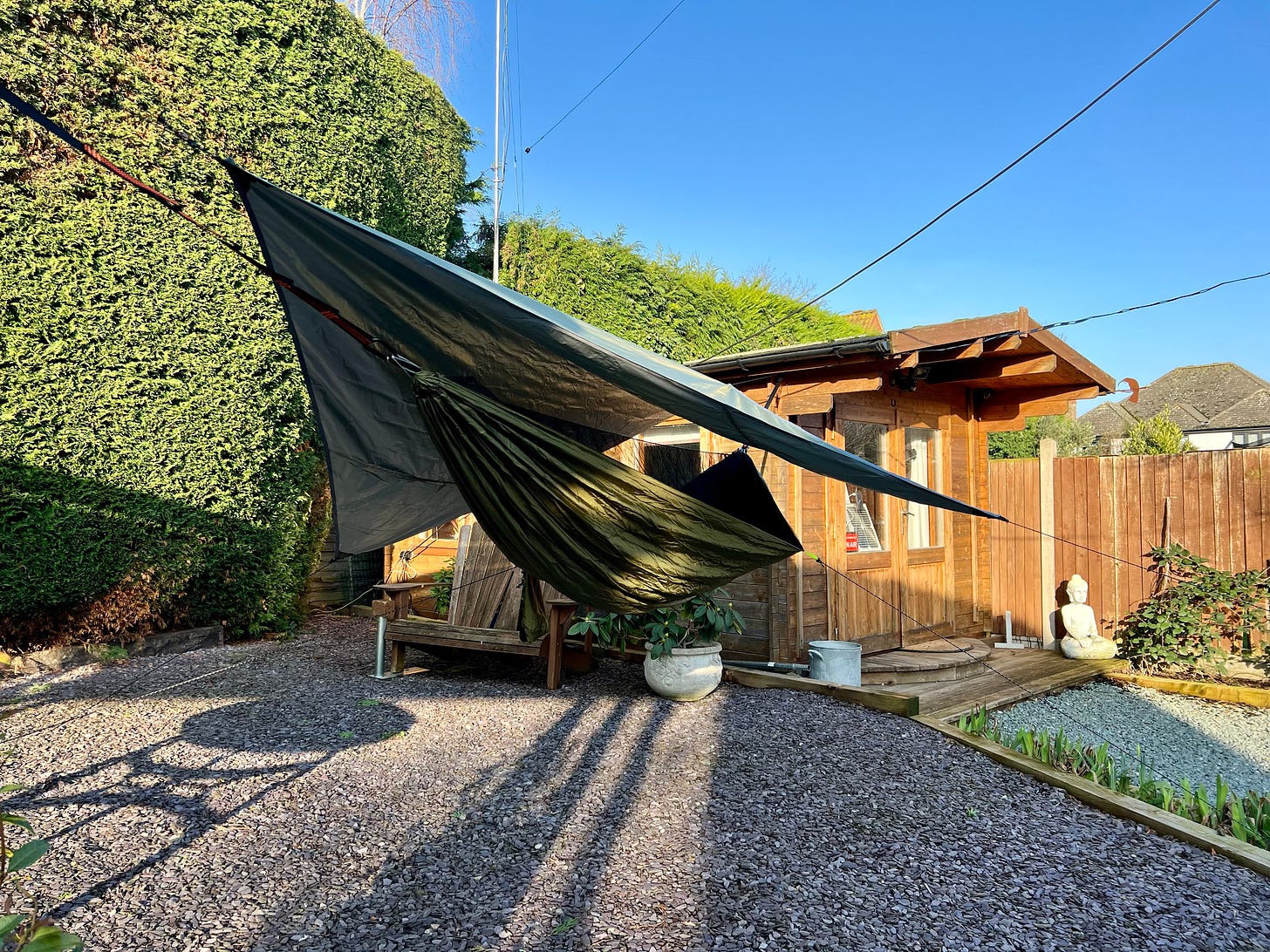 A camping hammock hangs by my shed