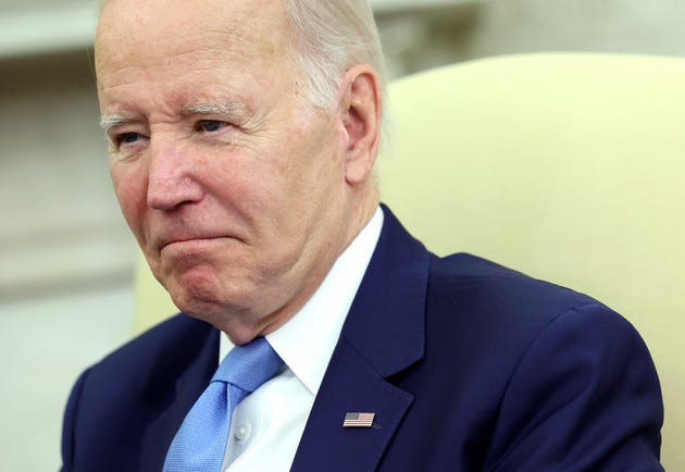 Close-up of Joe Biden in Oval Office chair.