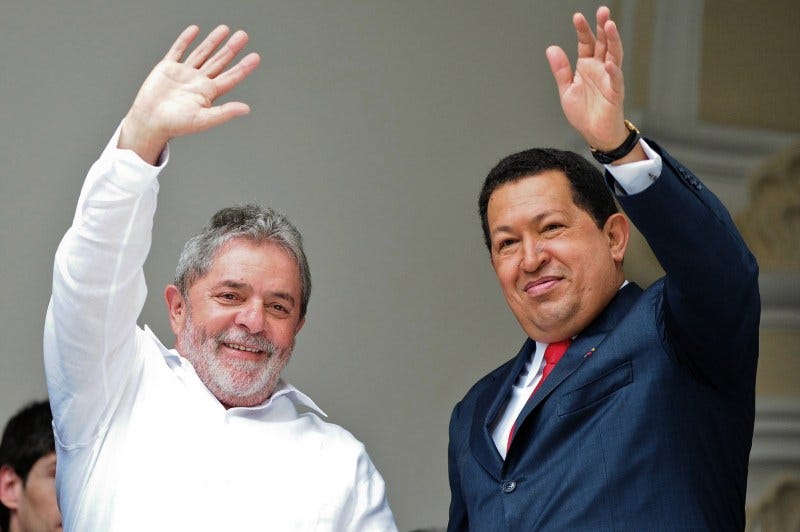 Venezuelan President Hugo Chavez (R) and Brazil's Luiz Inacio Lula da Silva wave during the South America-Africa (ASA) Strategic Presidential Committee, in Caracas, August 6, 2010. AFP PHOTO/Miguel Gutierrez (Photo credit should read MIGUEL GUTIERREZ/AFP/Getty Images)