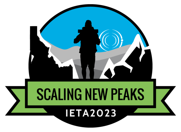 Conference 2023 logo, a person standing between mountains.