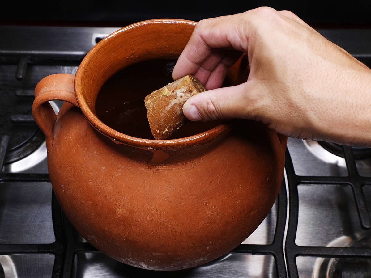 adding piloncillo to pot