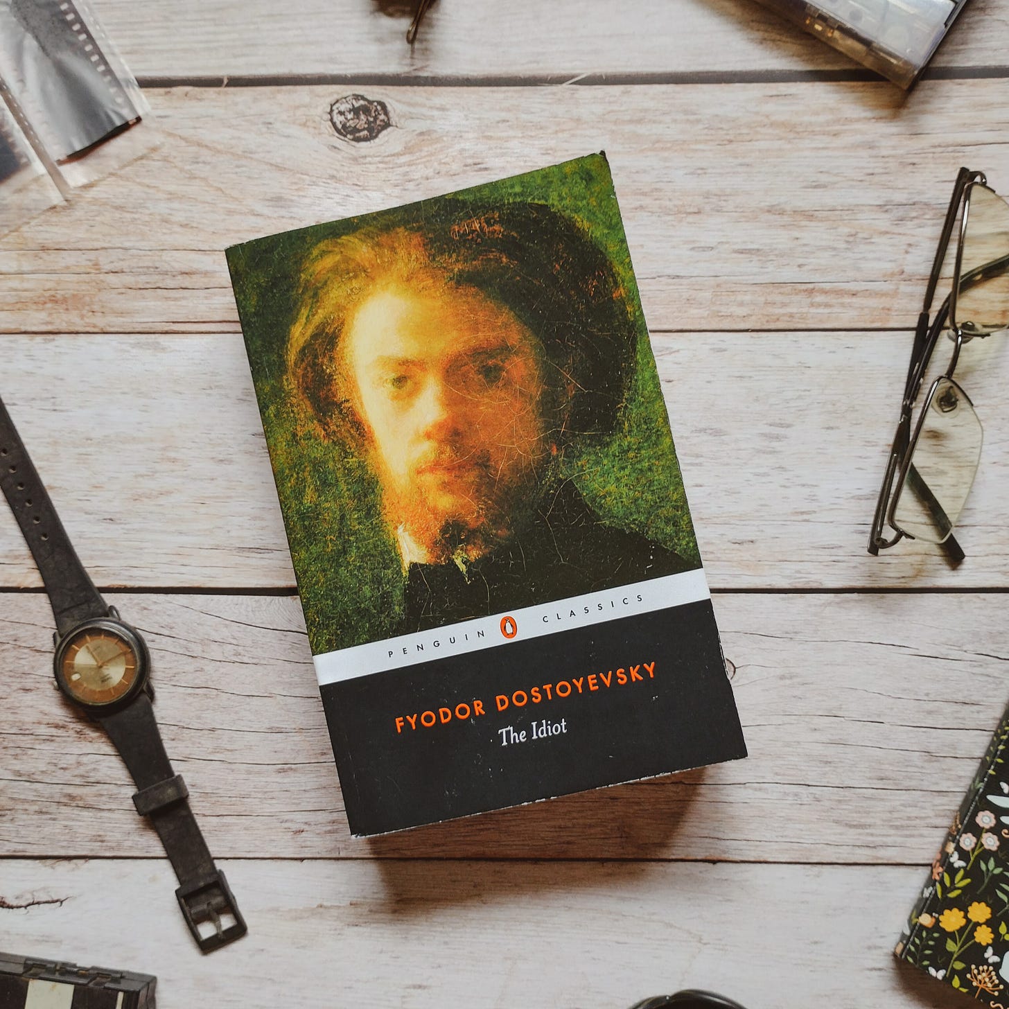 The Idiot by Fyodor Dostoevsky, Penguin black classic edition, on a wooden tabletop