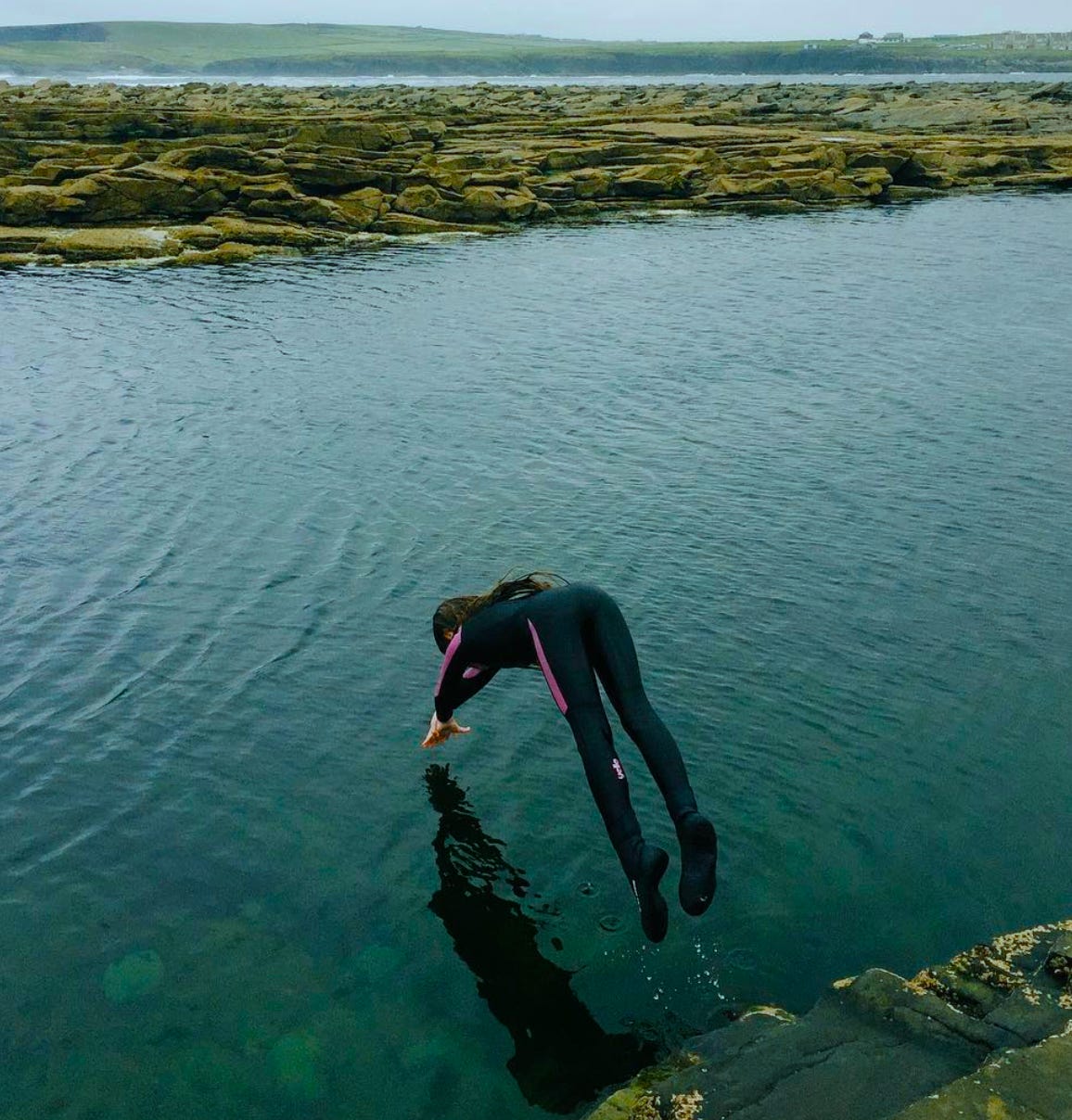 A young girl is frozen above water as she dives into a wading pool at the Kilkee Cliffs in County Clare, Ireland. 