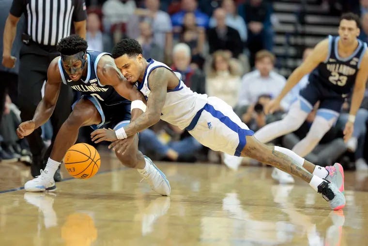 T.J. Bamba, left, of Villanova and Al-Amir Dawes of Seton Hall dive for the ball during the 2nd half on March 6, 2024 at the Prudential Center in Newark, N.J.