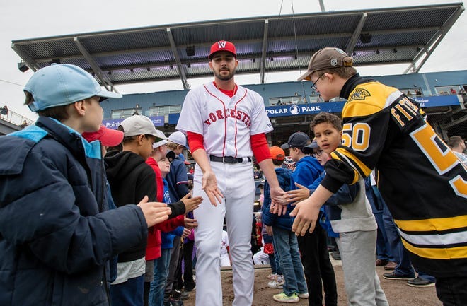 WooSox reliever Joe Jacques is announced and goes through a high-five line of Jesse Burkett Little League players during the home opener at Polar Park. Liam Fitzgerald of Northborough, known as the Bruins' fist-bump kid, is at far right.