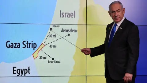 Reuters Israeli Prime Minister Benjamin Netanyahu stands before a map 