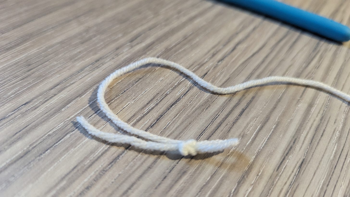 A loop of yarn with one bump on top and two bumps on the bottom