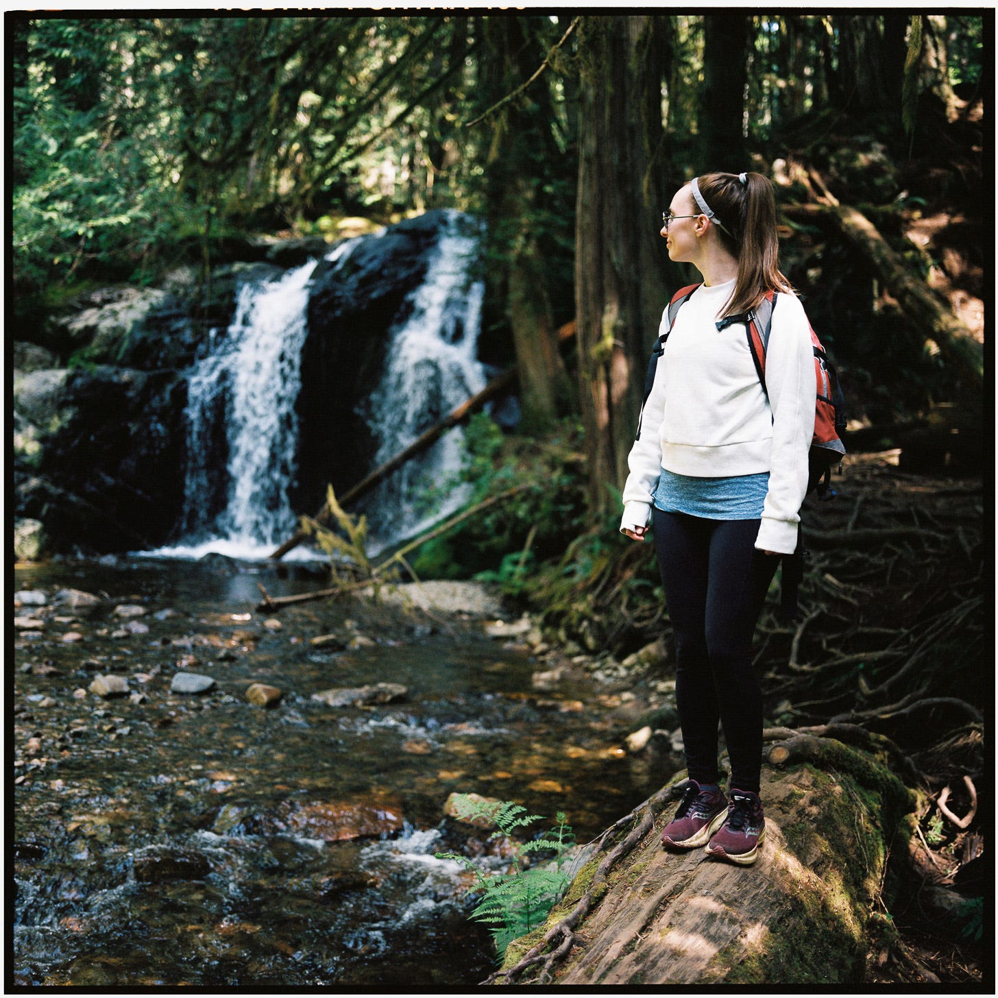 Photo of Maddie in front of a waterfall