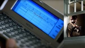 A scene from the Dilemma music video where Kelly Rowland is pictured in a window sending a message to Nelly via a two way pager on excel. 
