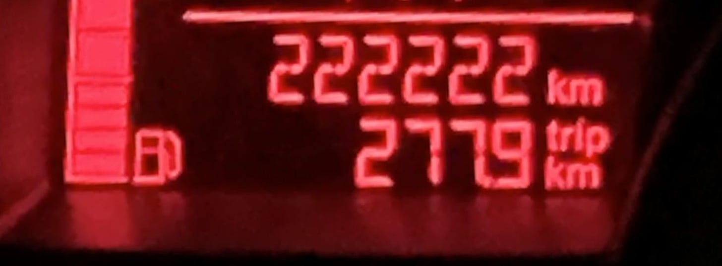 The car’s clock showing 222222 km with a black background lit up in red.