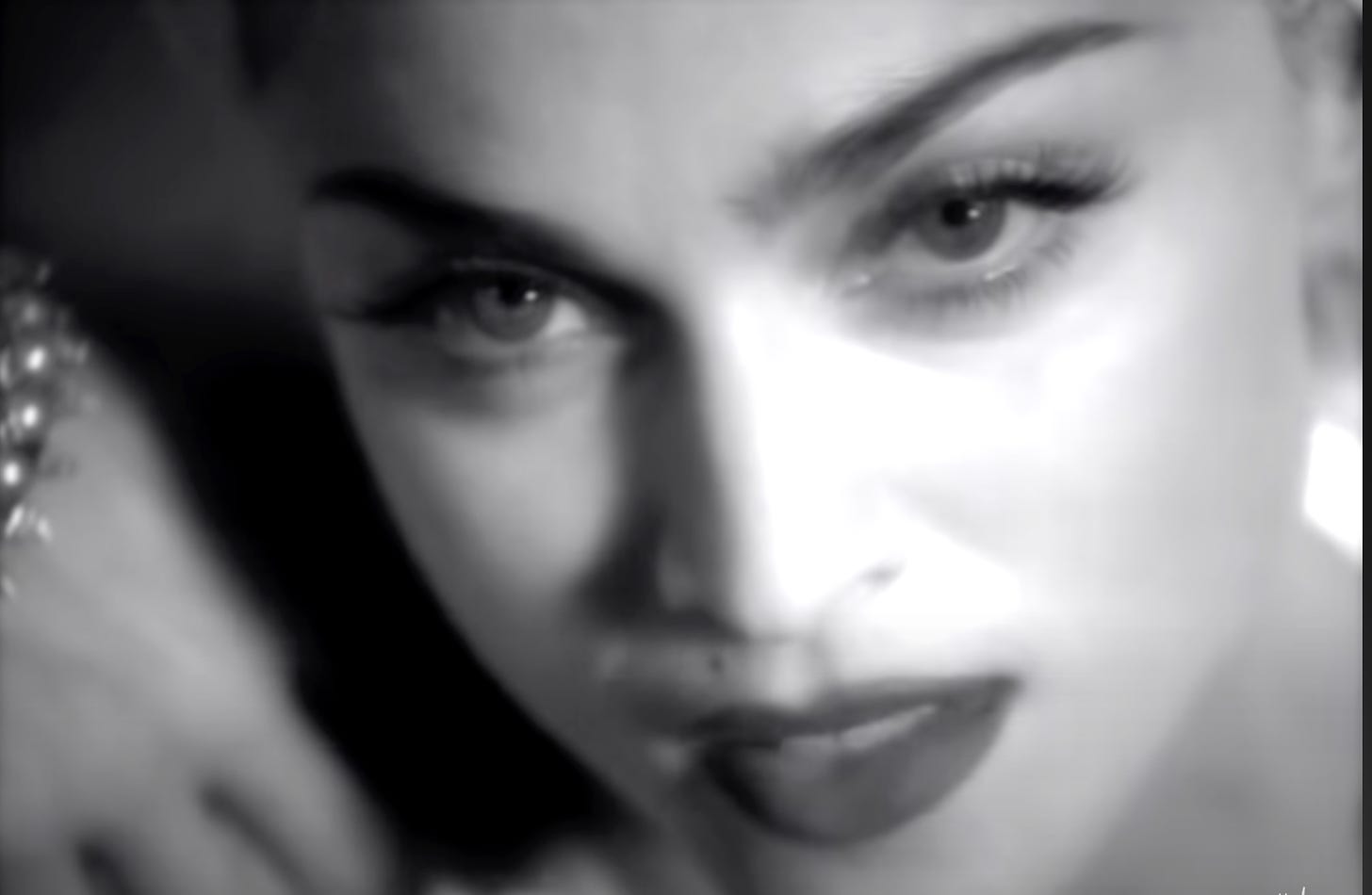 A closeup of madonna's face while she is rapping in Vogue