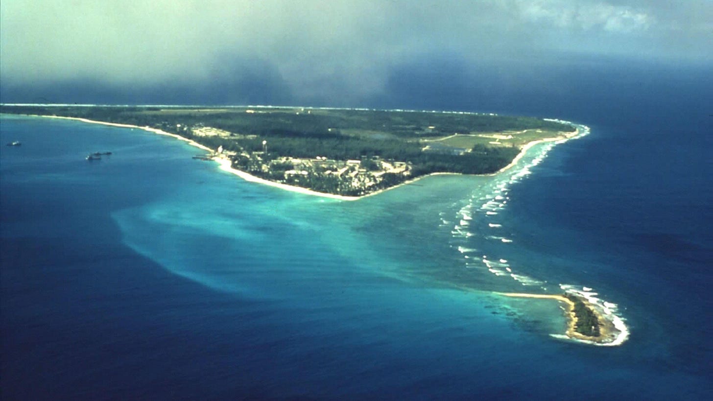 an aerial view of a small island in the middle of the ocean