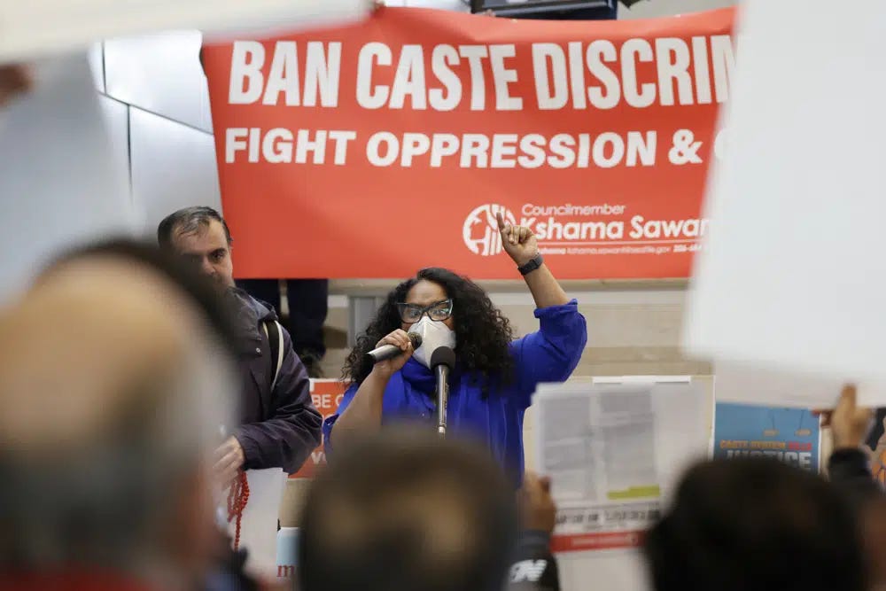 Thenmozhi Soundararajan, founder and executive director of Equality Labs, speaks to supporters and opponents a of a proposed ordinance to add caste to Seattle’s anti-discrimination laws rally at Seattle City Hall, Tuesday, Feb. 21, 2023, in Seattle. Council Member Kshama Sawant proposed the ordinance. (AP Photo/John Froschauer)