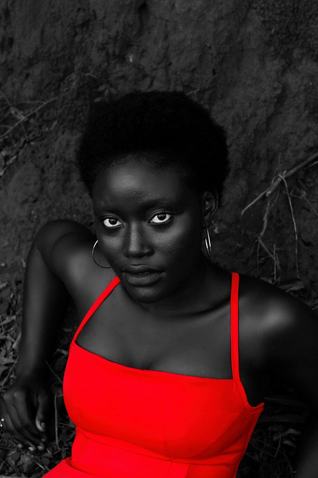 Black girl with stunning eyes, wearing a red dress.