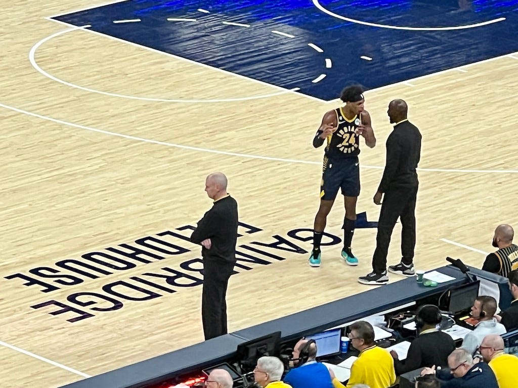 Pacers assistant coach Lloyd Pierce talks with Buddy Hield about a defensive matchup late in the Pacers’ win over the Bulls.